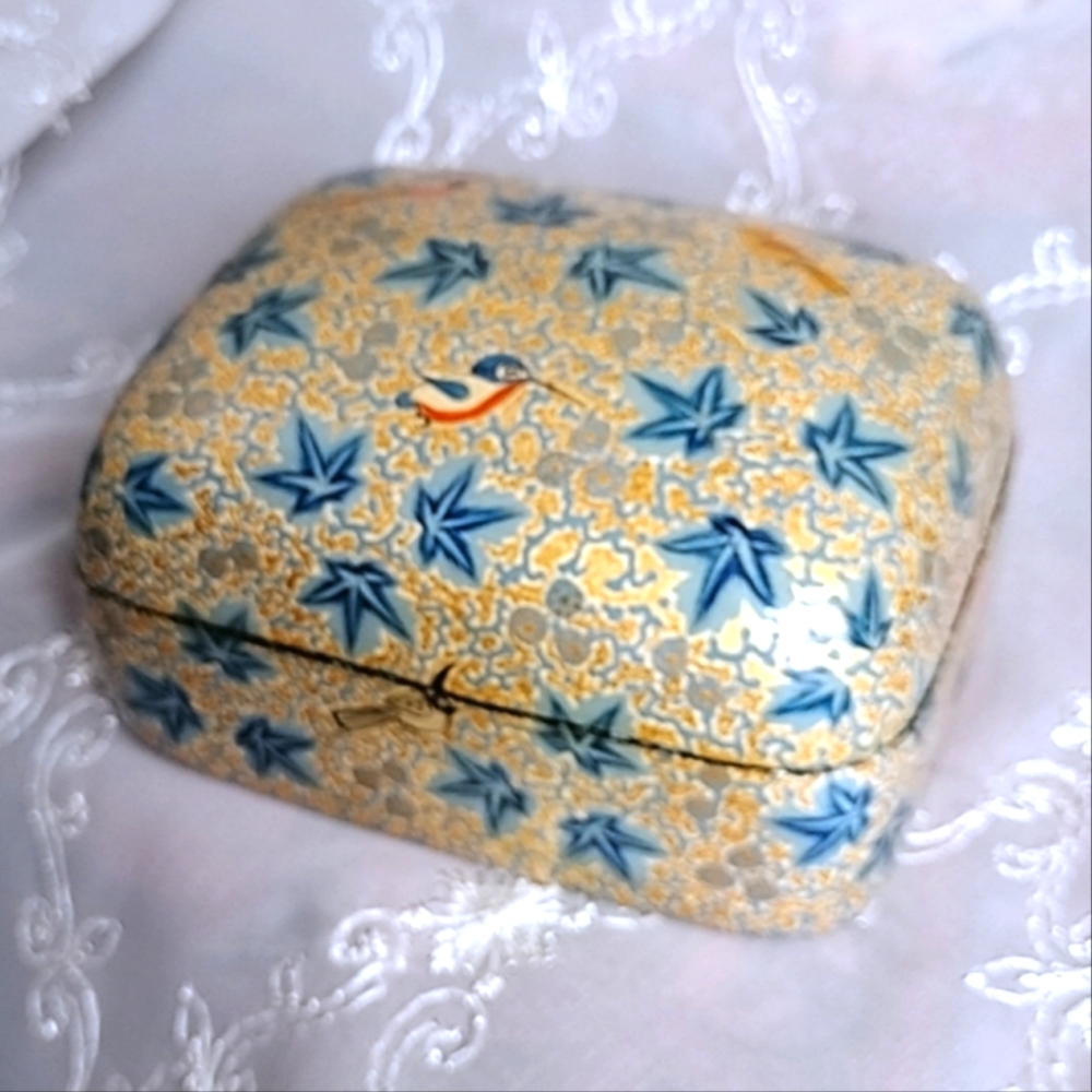 This trinket/jewelry box was hand made in India. It's very decorative with the g
